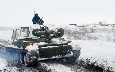 In this photo taken from video provided by the Russian Defense Ministry Press Service on January 26, 2022, a Russian self-propelled gun rolls during a military exercising at a training ground in Rostov region, Russia. (Russian Defense Ministry Press Service via AP)