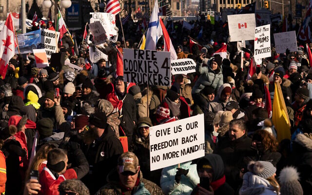 Canadian protesters participating in a cross-country truck convoy protesting measures taken by authorities to curb the spread of COVID-19 and vaccine mandates gather near Parliament Hill in Ottawa, on January 29, 2022. (Adrian Wyld/The Canadian Press via AP) Canadian protesters participating in a cross-country truck convoy protesting measures taken by authorities to curb the spread of COVID-19 and vaccine mandates gather near Parliament Hill in Ottawa, on January 29, 2022. (Adrian Wyld/The Canadian Press via AP)