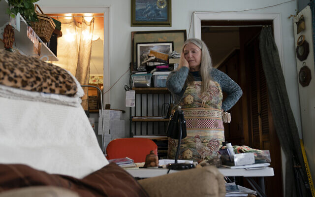 Nancy Rose, who contracted COVID-19 in 2021 and continues to exhibit long-haul symptoms including brain fog and memory difficulties, pauses while organizing her desk space, in Port Jefferson, New York, Jan. 25, 2022. (John Minchillo/AP) Nancy Rose, who contracted COVID-19 in 2021 and continues to exhibit long-haul symptoms including brain fog and memory difficulties, pauses while organizing her desk space, in Port Jefferson, New York, Jan. 25, 2022. (John Minchillo/AP)