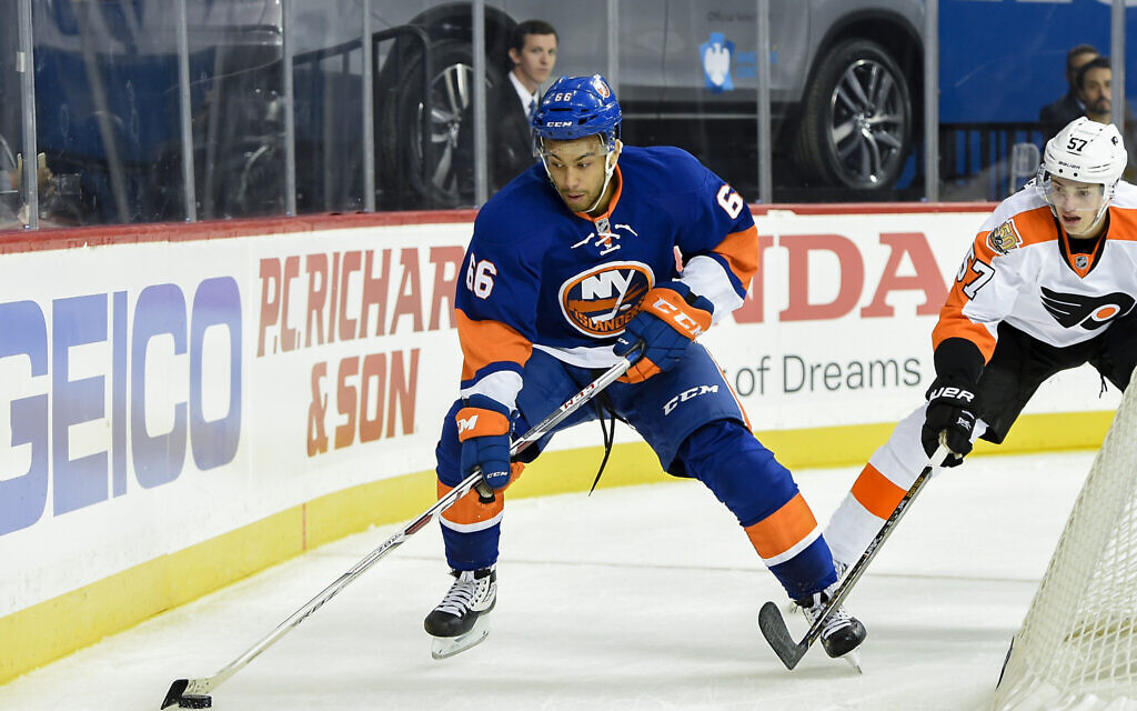 New York Islanders center Josh Ho-Sang (66) controls the puck against Philadelphia Flyers defenseman Travis Sanheim (57) in the second period of a preseason NHL hockey game in New York., Monday, Sept. 26, 2016. (AP Photo/Kathy Kmonicek)