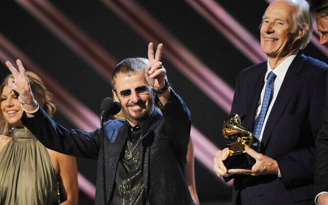 In this February 10, 2008, file photo, former Beatle Ringo Starr, center, and Beatles producer Sir George Martin accept the best compilation soundtrack album award for 'Love' during the 50th annual Grammy awards held at the Staples Center in Los Angeles. (AP Photo/Kevork Djansezian, File) In this February 10, 2008, file photo, former Beatle Ringo Starr, center, and Beatles producer Sir George Martin accept the best compilation soundtrack album award for 'Love' during the 50th annual Grammy awards held at the Staples Center in Los Angeles. (AP Photo/Kevork Djansezian, File)
