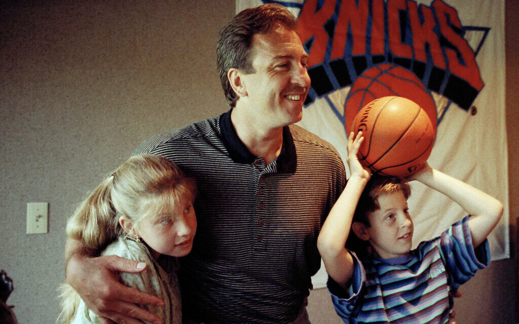 Ernie Grunfeld hugs his children, Rebecca, 12, and Danny, 9, at a news conference in Harrison, New York, July 21, 1993. (AP Photo/Mark Lennihan)