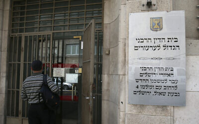 Illustrative: A woman stands outside the Jerusalem Rabbinic Court. (Nati Shohat/Flash 90)