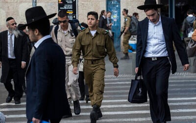 Illustrative: Ultra-Orthodox Jewish men walk alongside Israeli soldiers in Jerusalem on December 5, 2019. (Olivier Fitoussi/ Flash90)