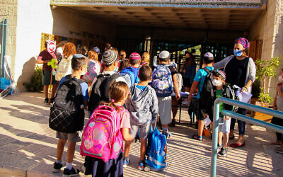 Illustrative: Israeli schoolchildren arrive for classes at a school in the West Bank settlement of Efrat on September 30, 2021. (Gershon Elinson/Flash90)