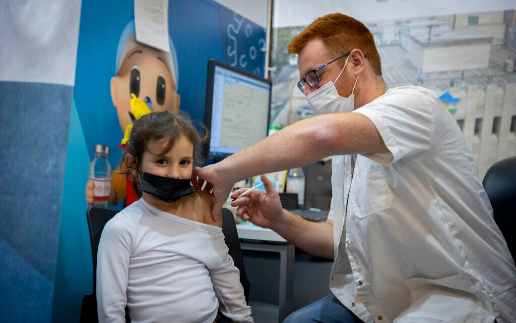 A child receives a dose of COVID-19 vaccine in Jerusalem on December 30, 2021 (Olivier Fitoussi/Flash90) A child receives a dose of COVID-19 vaccine in Jerusalem on December 30, 2021 (Olivier Fitoussi/Flash90)