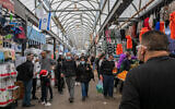 People shop at the market in the central town of Ramle, on December 31, 2021.(Yossi Aloni/Flash90)