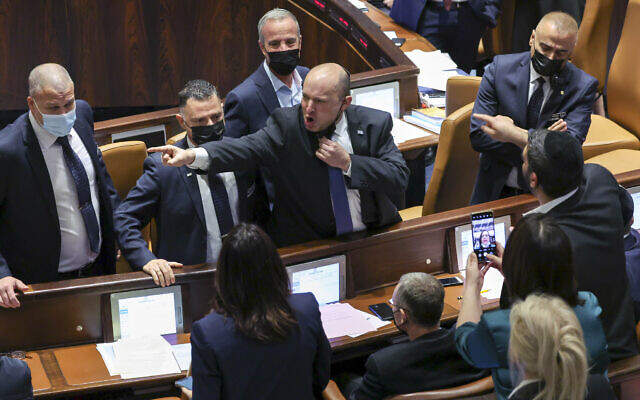 Prime Minister Naftali Bennett confronts and argues with opposition lawmakers in the Knesset during a vote on the electricity bill, Jerusalem, January 5, 2022 (Yonatan Sindel/Flash90) Prime Minister Naftali Bennett confronts and argues with opposition lawmakers in the Knesset during a vote on the electricity bill, Jerusalem, January 5, 2022 (Yonatan Sindel/Flash90)
