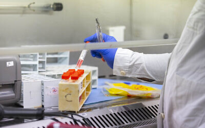 COVID-19 PCR tests are analyzed by medical staff at a Clalit Health Services lab in Jerusalem, on January 10, 2021. (Olivier Fitoussi/Flash90)