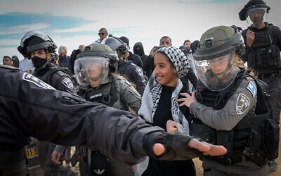 Israeli police officers guard outside the Bedouin village of Mulada, in the Negev on January 12, 2022. (Flash90) Israeli police officers guard outside the Bedouin village of Mulada, in the Negev on January 12, 2022. (Flash90)
