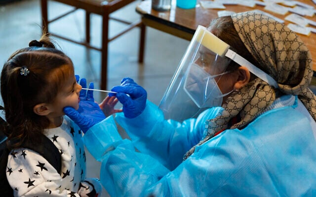 Illustrative: A health worker carries out a COVID-19 rapid antigen test in Jerusalem on January 12, 2022. (Olivier Fitoussi/Flash90)
