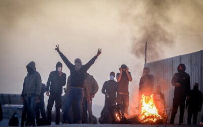Bedouin youth during a protest against tree planting by the Jewish National Fund, outside the Bedouin village of al-Atrash in the Negev desert, southern Israel, January 13, 2022 (Jamal Awad/Flash90)