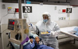 Healthcare workers wear safety gear as they work in the COVID ward of the Herzog Medical Center in Jerusalem, on January 13, 2022. (Yonatan Sindel/Flash90)