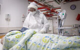 A medical worker wearing safety gear in the coronavirus ward of the Herzog Medical Center in Jerusalem, January 13, 2022. (Yonatan Sindel/Flash90)