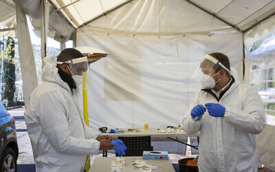 Workers at a drive-through testing complex in Jerusalem, on January 17, 2022. (Olivier Fitoussi/Flash90)