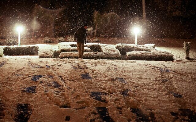 People in the snow in the nothern city of Safed, January 19, 2022. (David Cohen/Flash90) People in the snow in the nothern city of Safed, January 19, 2022. (David Cohen/Flash90)