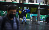 People wearing face masks are seen in central Jerusalem, January 19, 2022. (Olivier Fitoussi/Flash90)