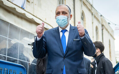 Shas party leader Aryeh Deri leaves the Jerusalem Magistrate's Court after pleading guilty on charges of tax offenses as part of a negotiated plea bargain, on January 25, 2022. (Yonatan Sindel/Flash90)