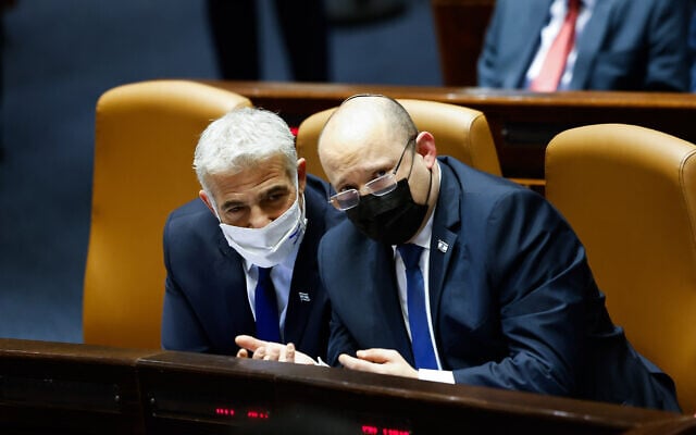 Prime Minister Naftali Bennett and Foreign Minister Yair Lapid (L) attend a Knesset plenum session on January 31, 2022. (Olivier Fitoussi/Flash90) Prime Minister Naftali Bennett and Foreign Minister Yair Lapid (L) attend a Knesset plenum session on January 31, 2022. (Olivier Fitoussi/Flash90)