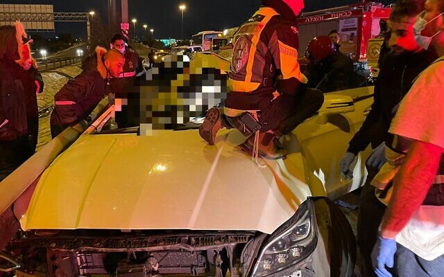 Rescue workers try and free two people trapped in their vehicle following a fatal traffic accident near Ramat Gan on January 18 2022 (Magen David Adom) Rescue workers try and free two people trapped in their vehicle following a fatal traffic accident near Ramat Gan on January 18 2022 (Magen David Adom)