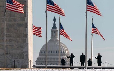 A year after the attack on the US Capitol, a US Navy Ceremonial Guard poses with their rifles during a photo session with a military photographer, in Washington, January 6, 2022. (AP Photo/Jacquelyn Martin)