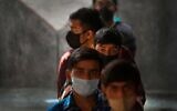 Children wait to receive COVID-19 vaccines at a government school in New Delhi, India, January 3, 2022. (AP Photo/Manish Swarup)