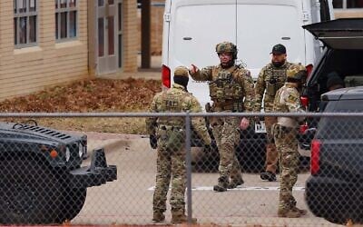SWAT team members deploy near Congregation Beth Israel Synagogue during a hostage situation in Colleyville, Texas, January 15, 2022. (Andy Jacobsohn/AFP) SWAT team members deploy near Congregation Beth Israel Synagogue during a hostage situation in Colleyville, Texas, January 15, 2022. (Andy Jacobsohn/AFP)