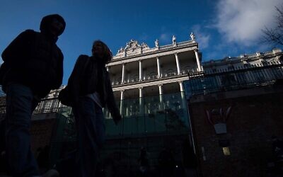 People walk past Palais Coburg, where closed-door nuclear talks take place in Vienna, Austria, December 17, 2021. (AP Photo/Michael Gruber)