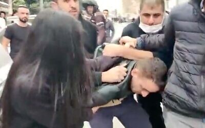 Police arrest ultra-Orthodox pedestrian Haim Mizrachi in Jerusalem, January 5, 2022. (Screenshot)