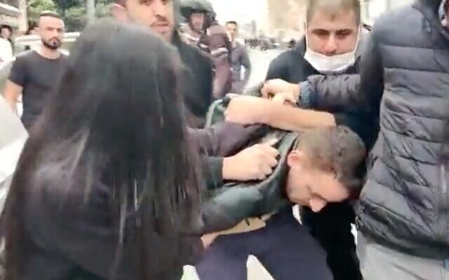 Police arrest ultra-Orthodox pedestrian Haim Mizrachi in Jerusalem, January 5, 2022. (Screenshot)