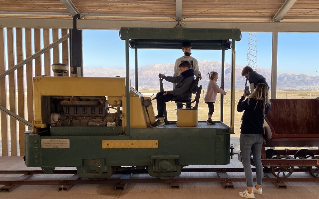 Young visitors enjoy clambering over an old engine at ICL's new Moshe Novomieski Visitors and Heritage Center at Sdom, southern Dead Sea, on January 20, 2022. (Sue Surkes/Times of Israel) Young visitors enjoy clambering over an old engine at ICL's new Moshe Novomieski Visitors and Heritage Center at Sdom, southern Dead Sea, on January 20, 2022. (Sue Surkes/Times of Israel)