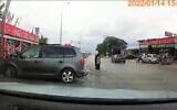 Video shows a man stealing a car (right) while the owner attempts to stop him in the Palestinian town of al-Auja on January 14, 2022. (Screenshot)