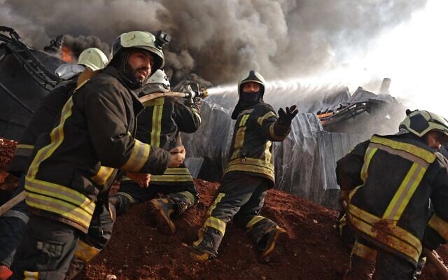 Syrian firefighters extinguish fire following artillery shelling by the Syrian regime on a fuel depot affiliated to the Hayat Tahrir al-Sham (HTS) jihadist group on February 16, 2022 in the northwestern rebel-held town of Dana. (Abdulaziz KETAZ / AFP) Syrian firefighters extinguish fire following artillery shelling by the Syrian regime on a fuel depot affiliated to the Hayat Tahrir al-Sham (HTS) jihadist group on February 16, 2022 in the northwestern rebel-held town of Dana. (Abdulaziz KETAZ / AFP)