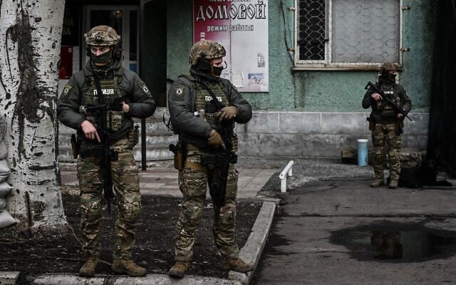 Ukrainian troops patrol in the town of Novoluhanske, eastern Ukraine, on February 19, 2022. (Aris Messins/AFP)