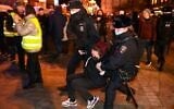 Police officers detain a woman during a protest against Russia's invasion of Ukraine in Moscow, on February 24, 2022. (Kirill Kudryavtsev/AFP)
