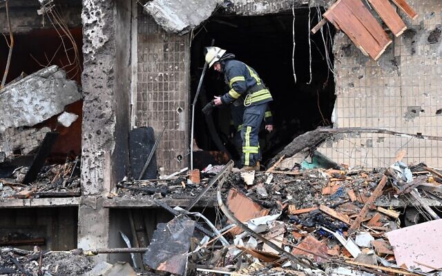 Firefighters work at a damaged residential building at Koshytsa Street, on the outskirts of the Ukrainian capital Kyiv, where a military shell allegedly hit, on February 25, 2022. (GENYA SAVILOV / AFP) Firefighters work at a damaged residential building at Koshytsa Street, on the outskirts of the Ukrainian capital Kyiv, where a military shell allegedly hit, on February 25, 2022. (GENYA SAVILOV / AFP)