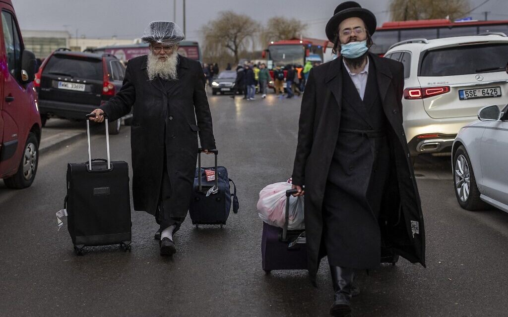 Two Orthodox Jews are seen arriving at the Medyka pedestrian border crossing in eastern Poland, fleeing the conflict in their country, one day after Russia launched a military attack on its neighbor Ukraine, February 25, 2022. (Wojtek Radwanski/AFP) Two Orthodox Jews are seen arriving at the Medyka pedestrian border crossing in eastern Poland, fleeing the conflict in their country, one day after Russia launched a military attack on its neighbor Ukraine, February 25, 2022. (Wojtek Radwanski/AFP)