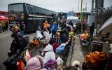 Ukrainian refugees wait to continue their journey after they crossed the border in Vysne Nemecke, eastern Slovakia, on February 26, 2022. (Peter Lazar/AFP)