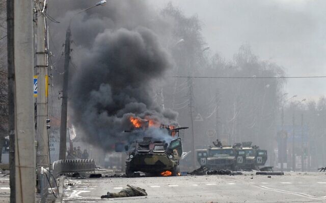 This photograph, taken on February 27, 2022, shows a Russian Armoured personnel carrier (APC) burning next to an unidentified soldier's body during a fight with the Ukrainian armed forces in Kharkiv. (Sergey Bobok/AFP) This photograph, taken on February 27, 2022, shows a Russian Armoured personnel carrier (APC) burning next to an unidentified soldier's body during a fight with the Ukrainian armed forces in Kharkiv. (Sergey Bobok/AFP)