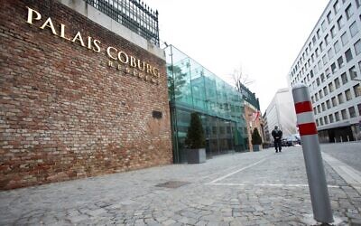 A police officer patrols outside the Hotel Palais Coburg in Vienna, where talks are being held on reviving the 2015 Iran nuclear deal, December 27, 2021. (Alex Halada/AFP)
