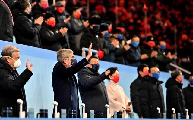 UN Secretary-General Antonio Guterres (left), International Olympic Committee (IOC) President Thomas Bach (2nd from left) and China's President Xi Jinping (3rd from left) wave during the opening ceremony of the Beijing 2022 Winter Olympic Games, at the National Stadium, known as the Bird's Nest, in Beijing, on February 4, 2022. (Anthony Wallace/Pool/AFP) UN Secretary-General Antonio Guterres (left), International Olympic Committee (IOC) President Thomas Bach (2nd from left) and China's President Xi Jinping (3rd from left) wave during the opening ceremony of the Beijing 2022 Winter Olympic Games, at the National Stadium, known as the Bird's Nest, in Beijing, on February 4, 2022. (Anthony Wallace/Pool/AFP)
