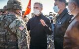 NATO Secretary General Jens Stoltenberg (center) and Romania's President Klaus Iohannis (center right) visit the Mihail Kogalniceanu Military Base, on February 11, 2022, in Mihail Kogalniceanu, Romania. (Andrei Pungovschi/AFP)