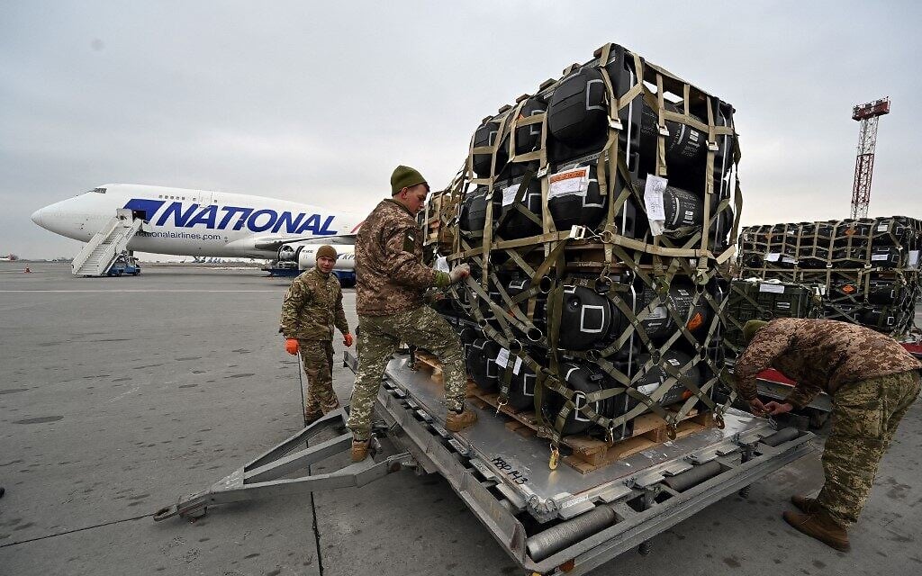 Ukrainian servicemen are at work to receive the delivery of FGM-148 Javelins, American man-portable anti-tank missile provided by US to Ukraine as part of a military support, at Kyiv's airport Boryspil, on February 11,2022. (Sergei Supinsky/AFP)