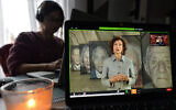 A woman watches Audrey Azoulay, UNESCO's director-general, speak during an online commemoration on International Holocaust Remembrance Day in Dublin, Jan. 27, 2021. (Artur Widak/NurPhoto via Getty Images/JTA)