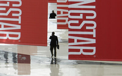 Attendees of a Morningstar investment conference walk beneath banners at the McCormick Center in Chicago, on June 24, 2010. (AP Photo/M. Spencer Green, File)
