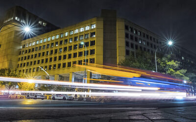 Traffic along Pennsylvania Avenue in Washington streaks past the Federal Bureau of Investigation headquarters building on Nov. 1, 2017. (AP Photo/J. David Ake)