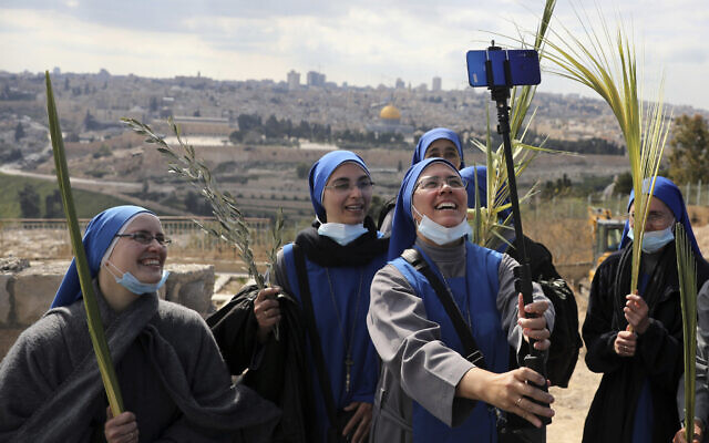 Nuns pose for a selfie as they mark Palm Sunday on the Mount of Olives in Jerusalem, Sunday, March 28, 2021. (AP Photo/Mahmoud Illean) Nuns pose for a selfie as they mark Palm Sunday on the Mount of Olives in Jerusalem, Sunday, March 28, 2021. (AP Photo/Mahmoud Illean)