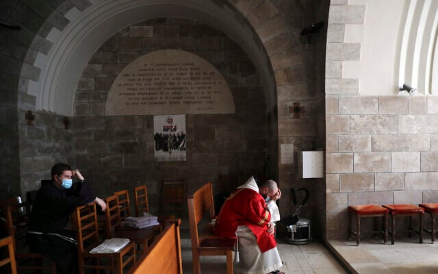 Priests pause on Palm Sunday on the Mount of Olives in Jerusalem, on Sunday, March 28, 2021. (AP Photo/Mahmoud Illean) Priests pause on Palm Sunday on the Mount of Olives in Jerusalem, on Sunday, March 28, 2021. (AP Photo/Mahmoud Illean)