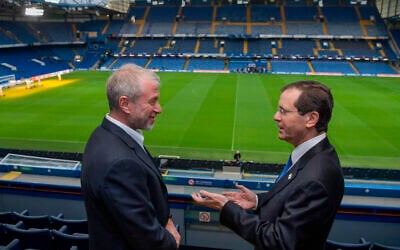In this photo, released by the Israel’s Government Press Office, Chelsea owner Roman Abramovich (left) talks with Israeli President Isaac Herzog at Stamford Bridge, in London, November 21, 2021. (Kobi Gideon/Israel’s Government Press Office via AP)