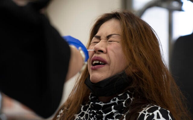 A woman takes a PCR coronavirus test at a private nursing home in Netanya. (AP Photo/Ariel Schalit) A woman takes a PCR coronavirus test at a private nursing home in Netanya. (AP Photo/Ariel Schalit)